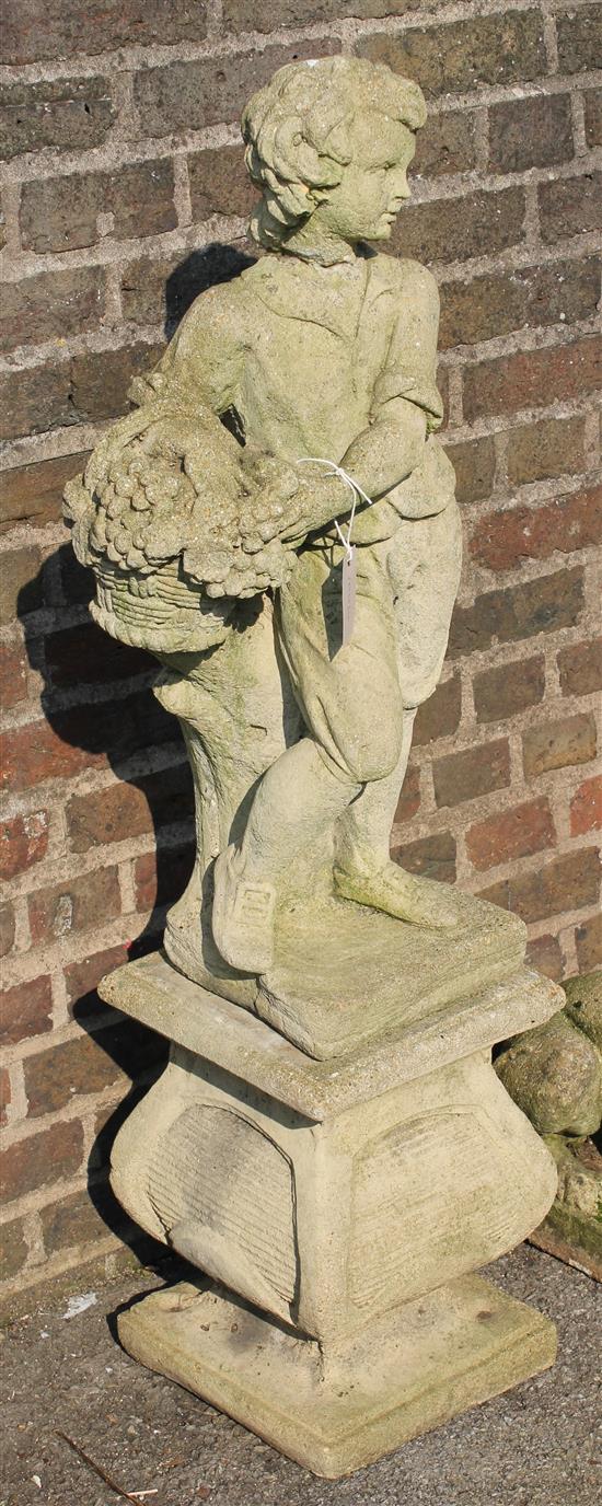Reconstituted stone garden figure of a boy with a basket, on a plinth
